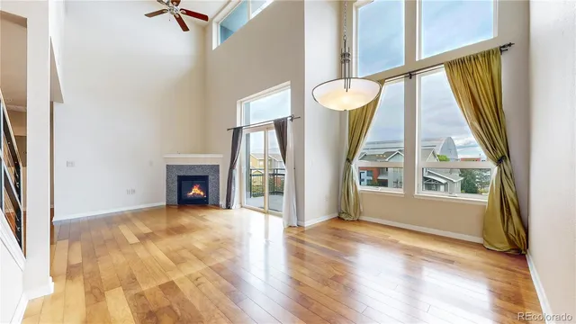 a view of an empty room with a fireplace and a window