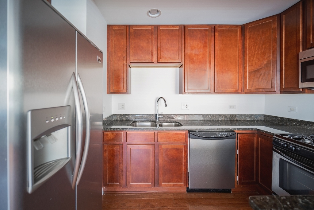 515 Sheridan Road, Unit 101 Evanston, IL 60202 - Photo 16 of 18 a kitchen with stainless steel appliances granite countertop a sink stove and refrigerator