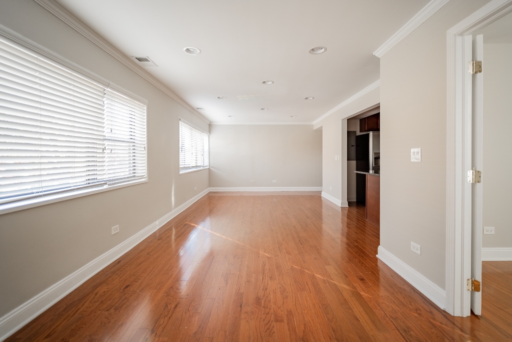 515 Sheridan Road, Unit 101 Evanston, IL 60202 - Photo 5 of 18 a view of an empty room with wooden floor and a window