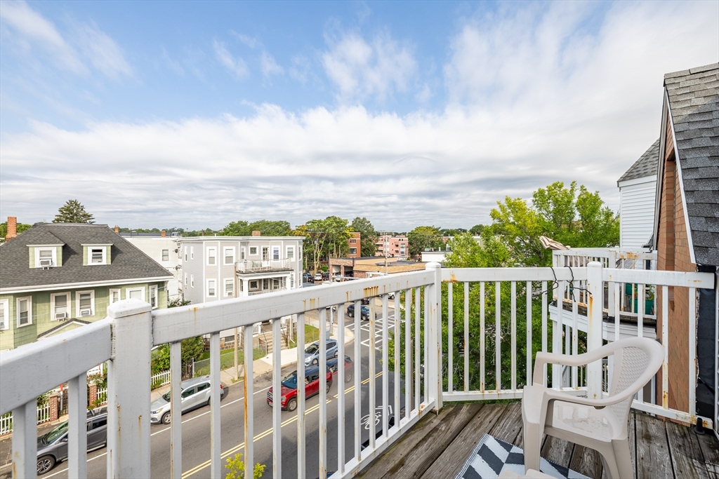 336 Adams Street, Unit 22 Boston, MA 02122 - Photo 9 of 9 a view of a city from a balcony with wooden floor