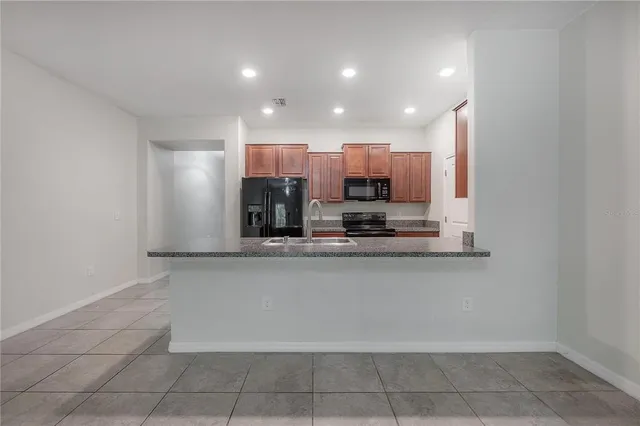 a kitchen with a sink and a refrigerator