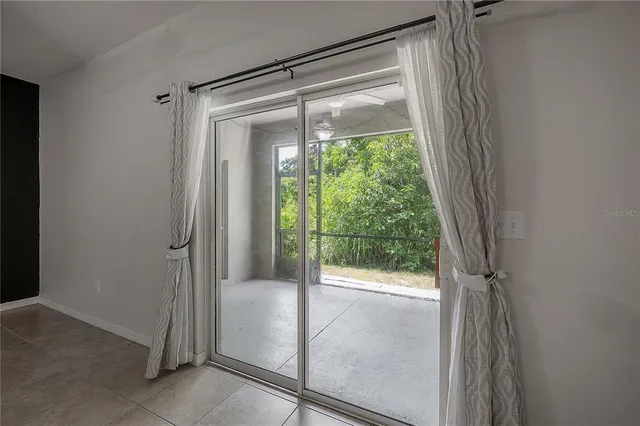 en empty room with windows and fan