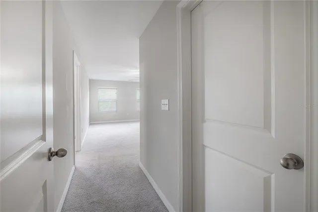 a view of an empty room with a fan