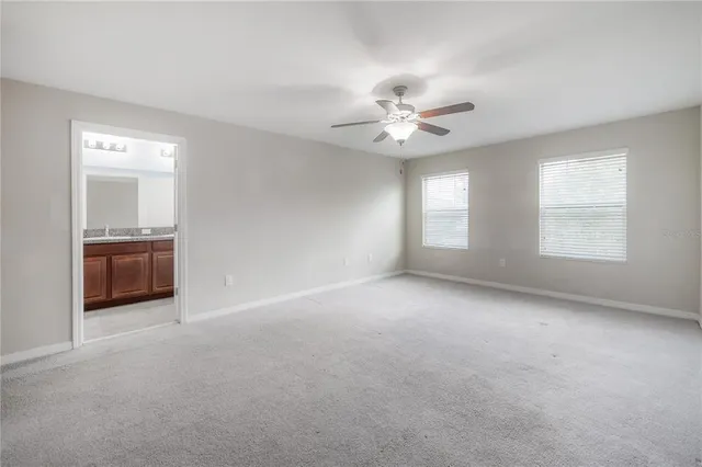 a bathroom with a granite countertop sink a toilet and a mirror
