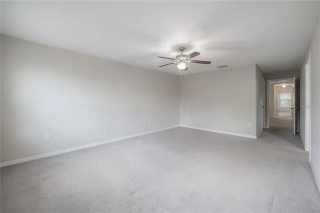 a bathroom with a granite countertop sink and a toilet