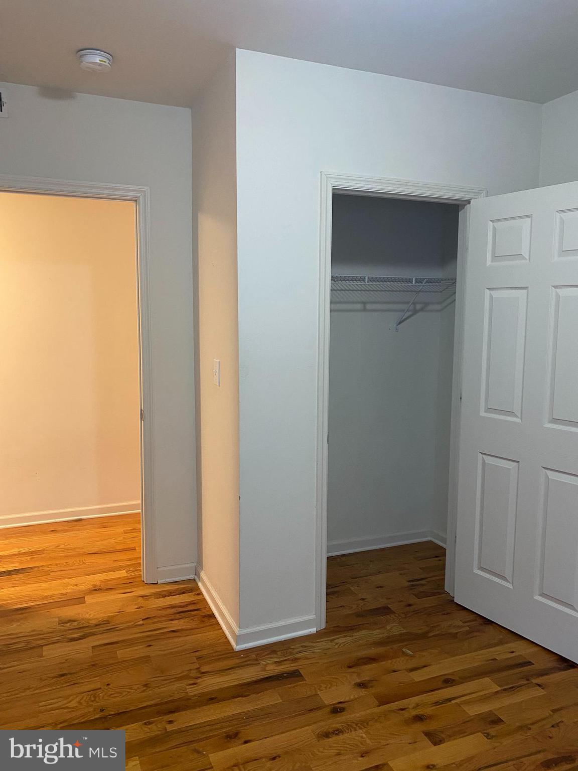 58 South Broadway, Unit 58C Pitman, NJ 08071 - Photo 24 of 35 a view of an empty room with wooden floor and a window