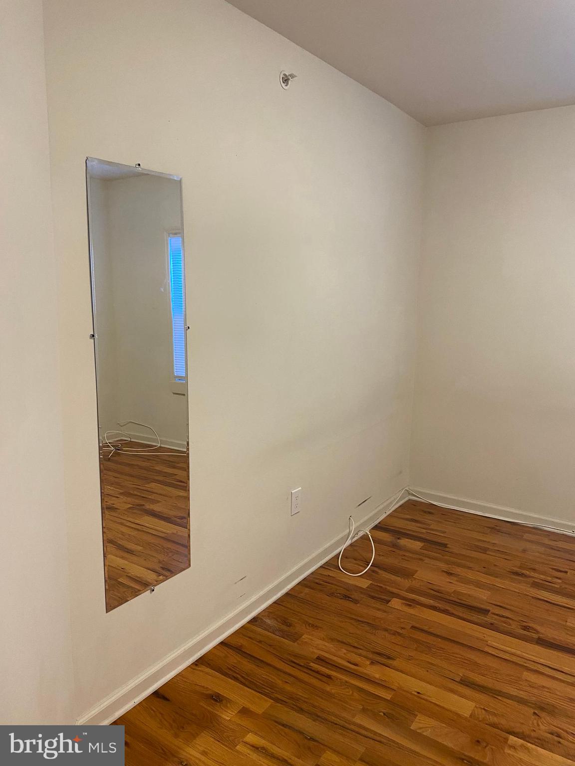58 South Broadway, Unit 58C Pitman, NJ 08071 - Photo 28 of 35 a view of a room with wooden floor and white walls