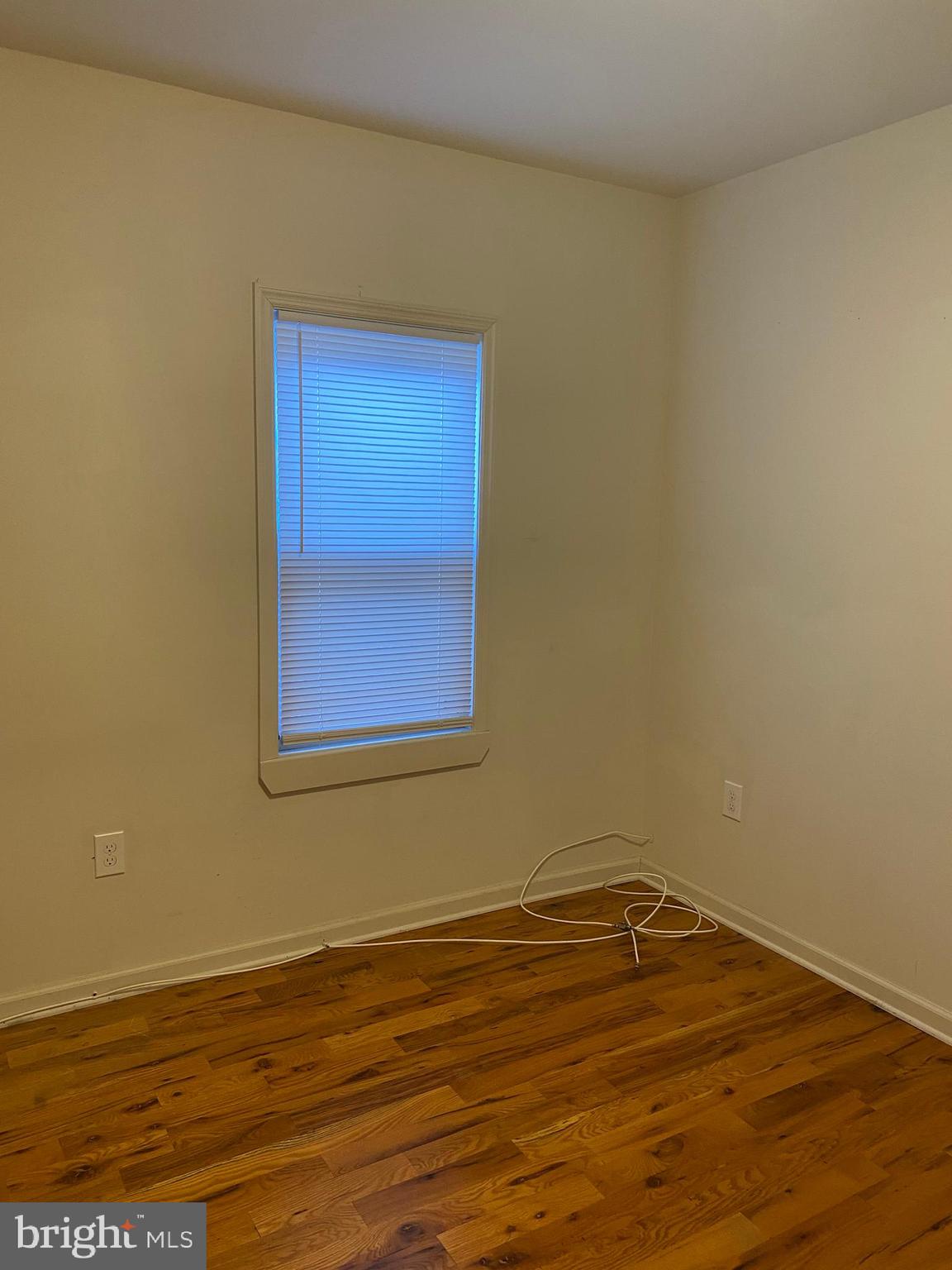58 South Broadway, Unit 58C Pitman, NJ 08071 - Photo 29 of 35 a view of a room with wooden floor and white walls