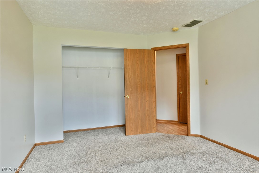 3287 Pheasant Run Road, Unit B Cortland, OH 44410 - Photo 10 of 45 Plush carpeting throughout with a built-in closet featuring wire shelving