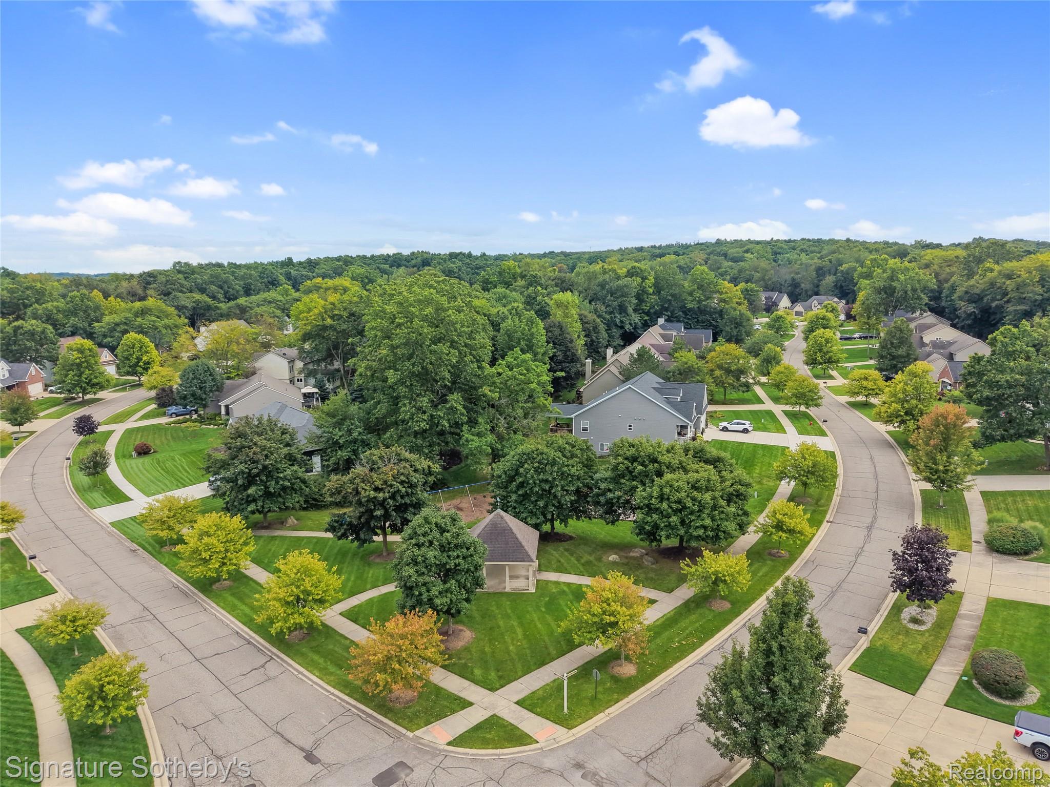 170 Fairhill Way Howell, MI 48843 - Photo 51 of 60 Curved streets with sidewalks, mature trees, and community park