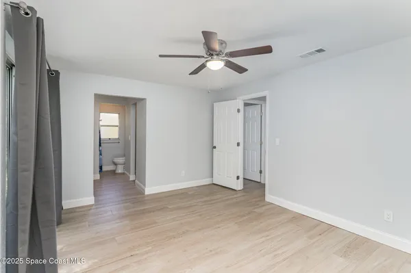 a view of an empty room and wooden floor
