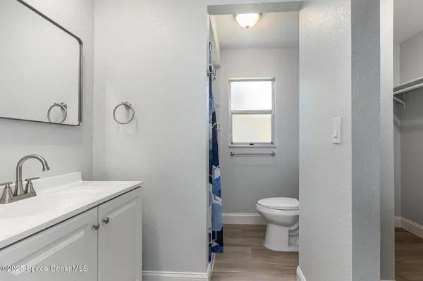 a bathroom with a toilet sink and a mirror