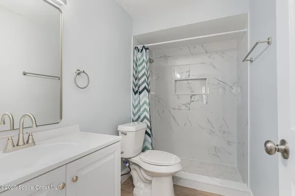 a bathroom with a sink toilet and shower