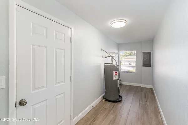 a view of empty room with wooden floor