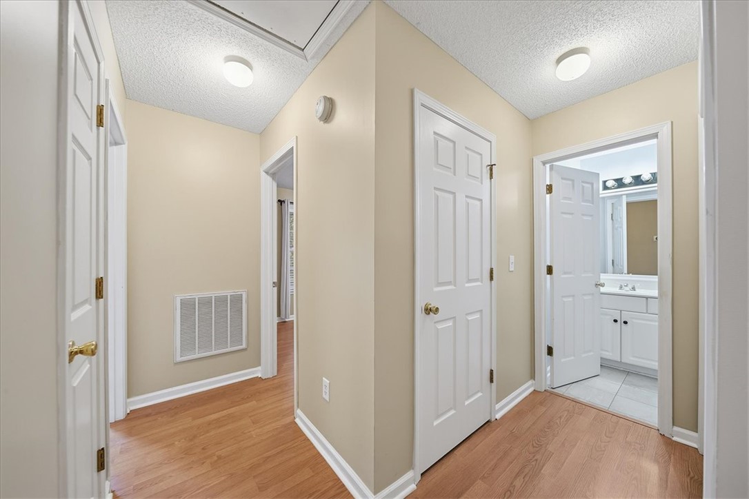 101 Grand Oak Circle Pendleton, SC 29670 - Photo 18 of 40 Streamlined hallway with durable hardwood floors leading to private rooms.