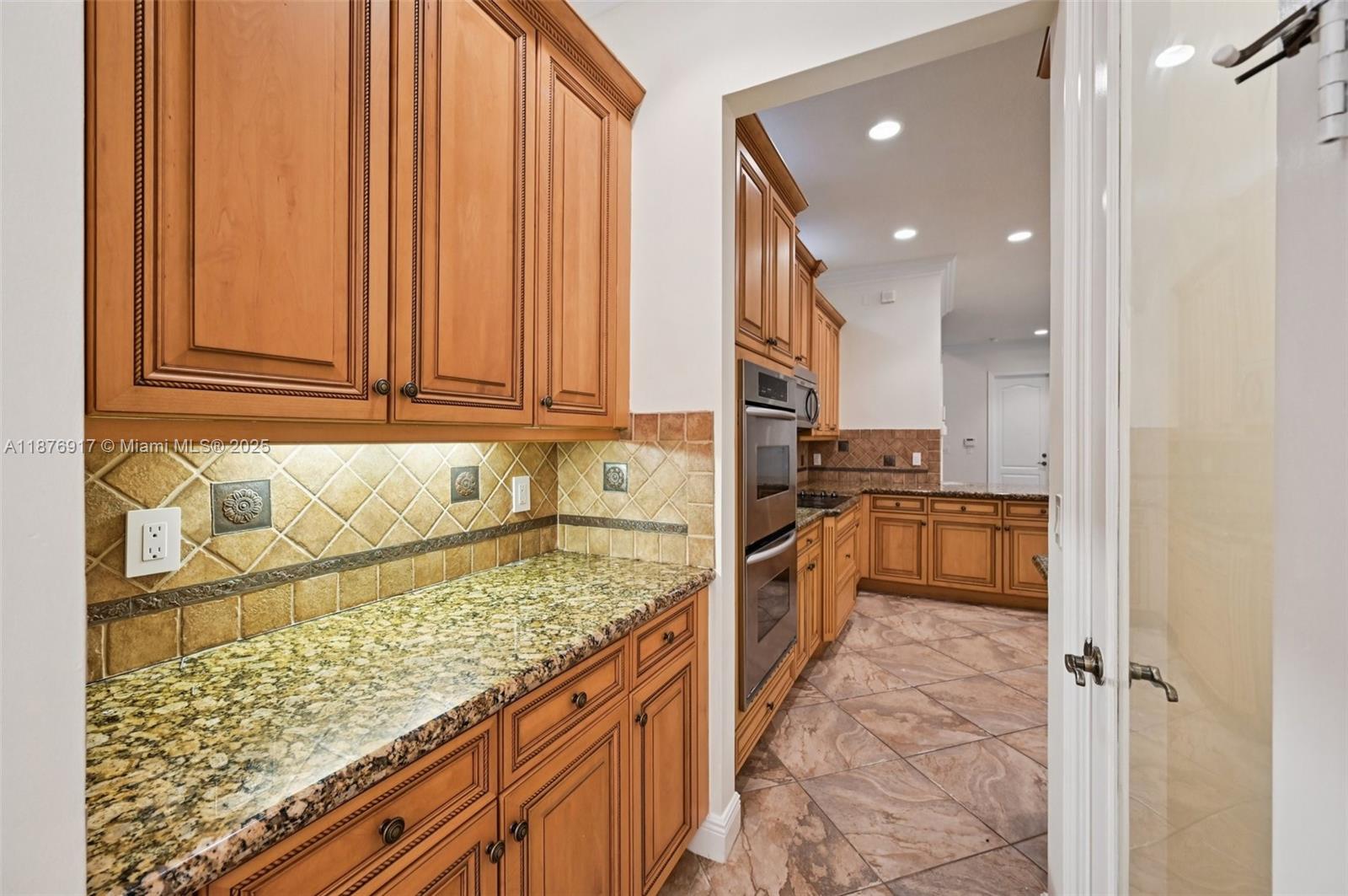 9192 Nugent Trail West Palm Beach, FL 33411 - Photo 11 of 62 a kitchen with stainless steel appliances granite countertop a refrigerator and a sink