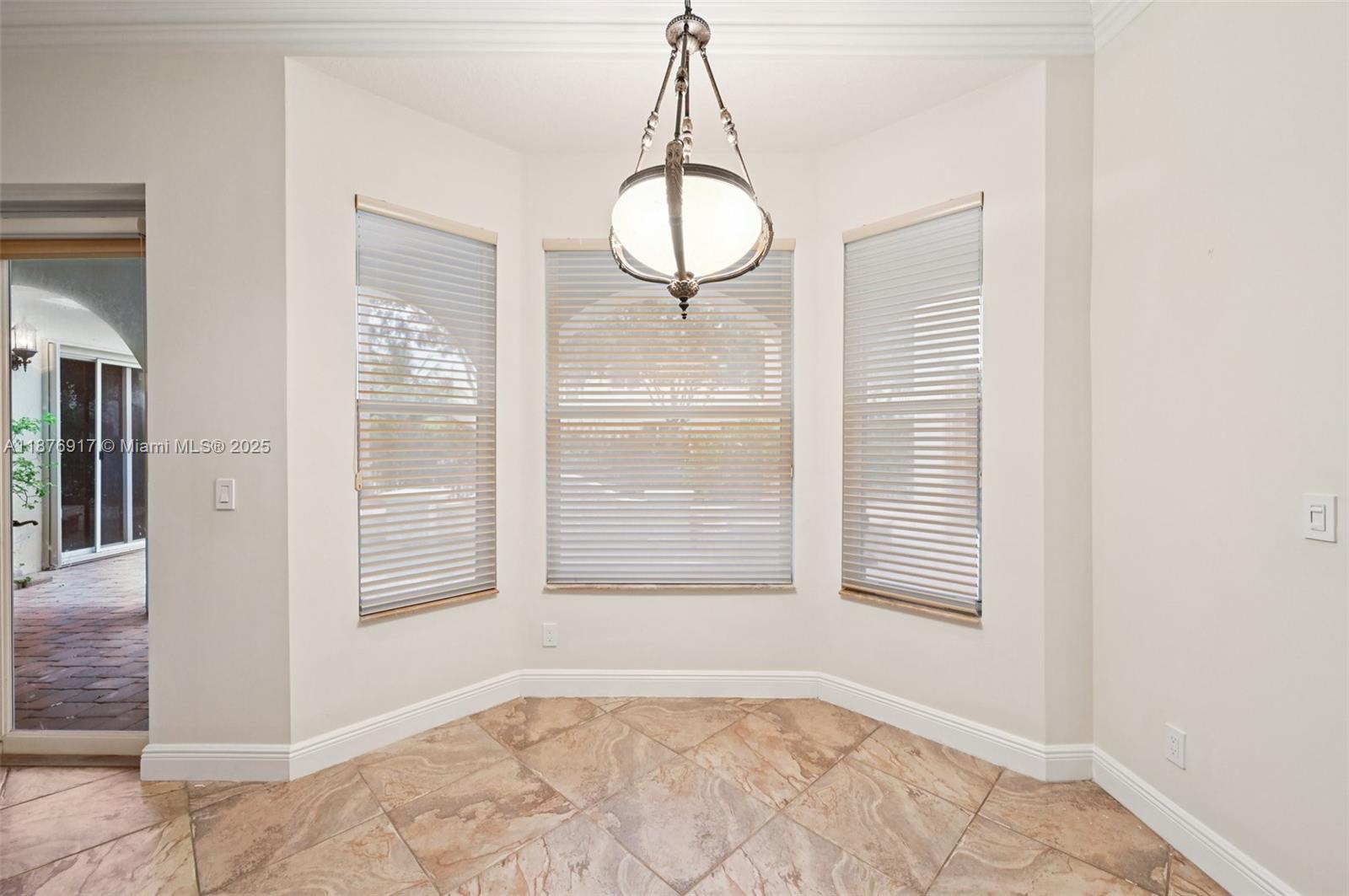 9192 Nugent Trail West Palm Beach, FL 33411 - Photo 13 of 62 a view of an empty room with wooden floor and a window