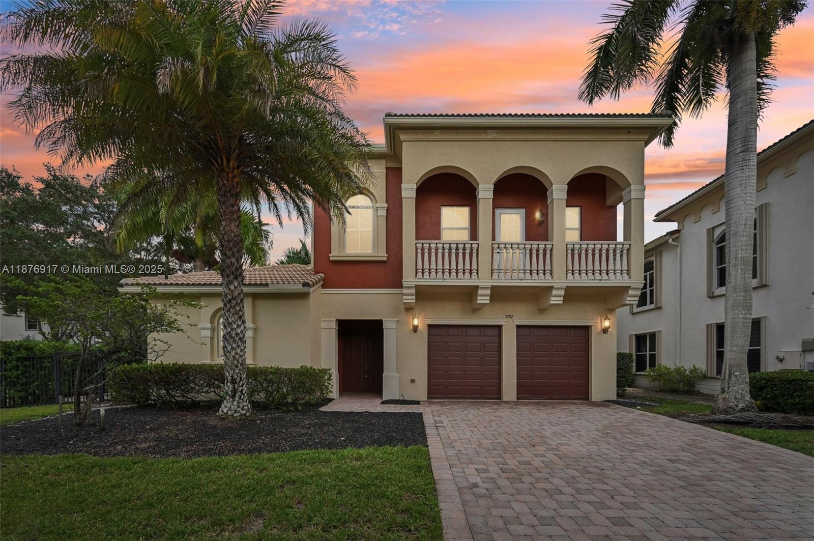9192 Nugent Trail West Palm Beach, FL 33411 - Photo 2 of 62 a front view of a house with a garden and palm trees