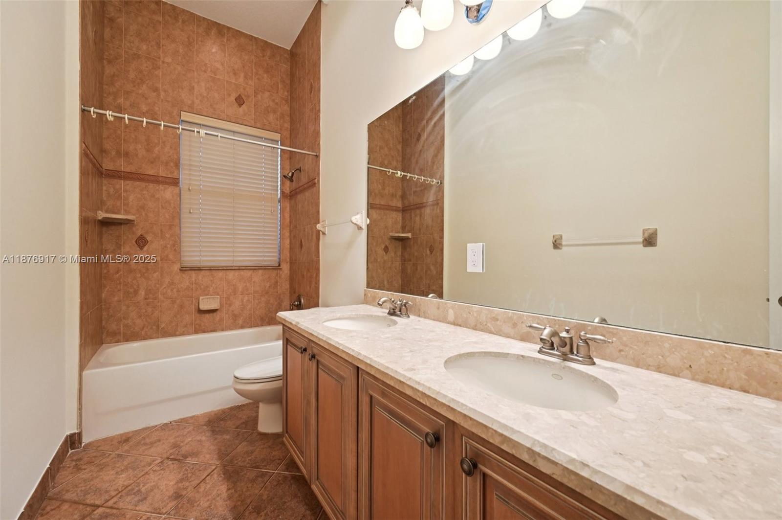 9192 Nugent Trail West Palm Beach, FL 33411 - Photo 30 of 62 a bathroom with a granite countertop sink toilet and shower