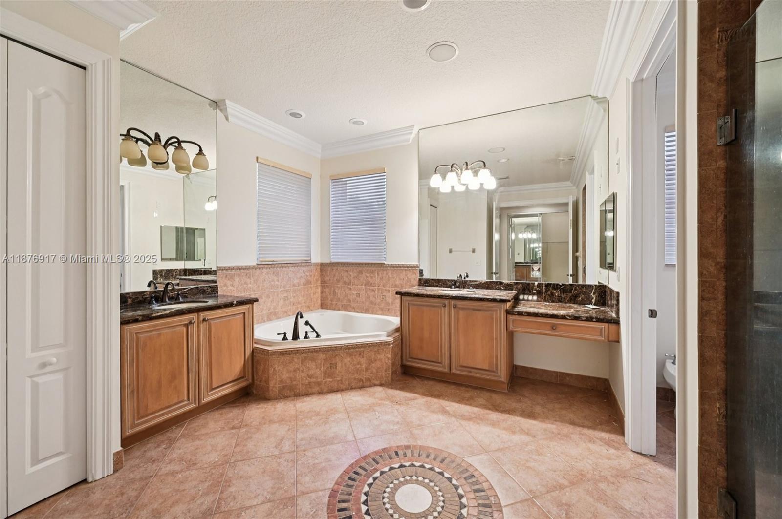 9192 Nugent Trail West Palm Beach, FL 33411 - Photo 34 of 62 a large bathroom with a granite countertop tub double vanity sink and a mirror