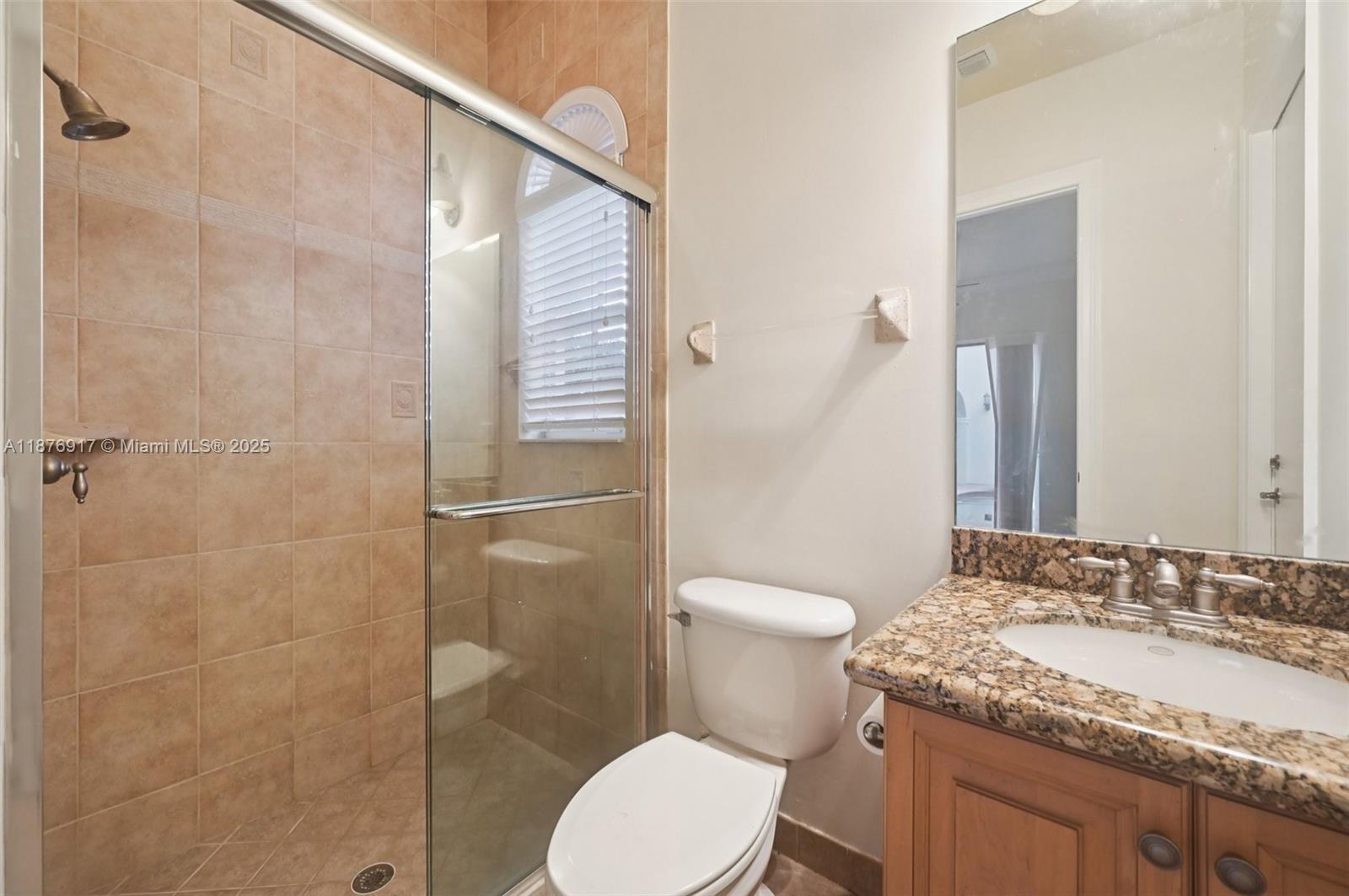 9192 Nugent Trail West Palm Beach, FL 33411 - Photo 38 of 62 a bathroom with a granite countertop sink toilet and shower