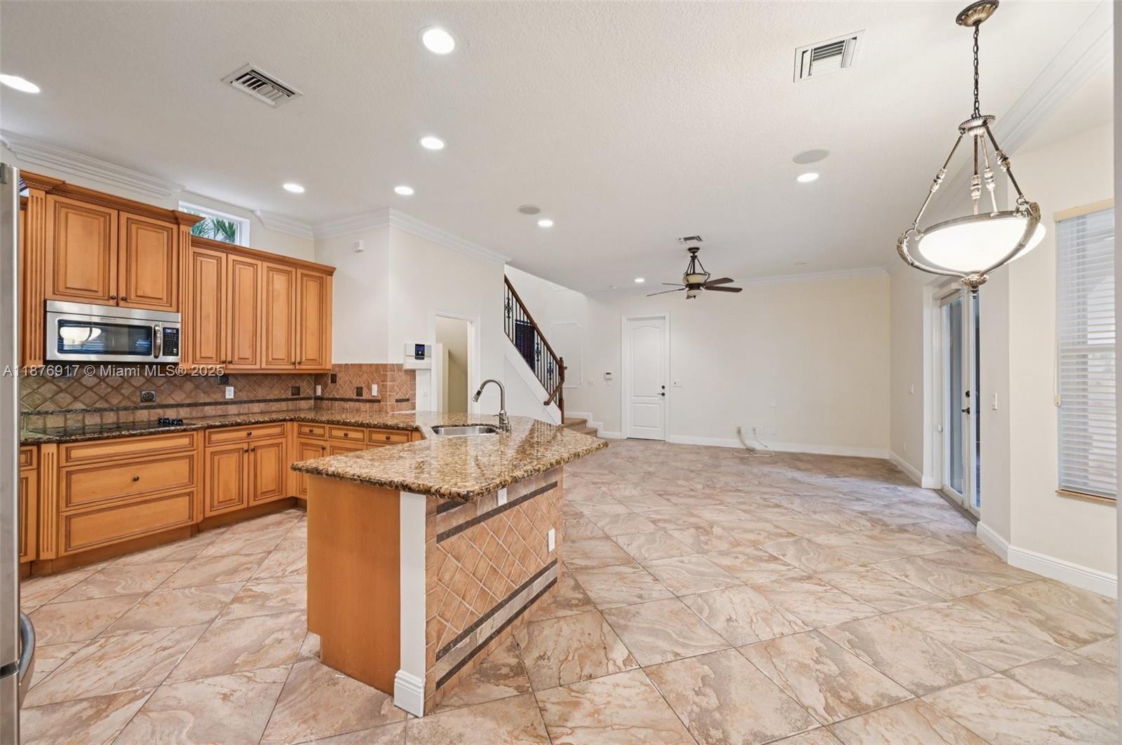 9192 Nugent Trail West Palm Beach, FL 33411 - Photo 4 of 62 a kitchen with stainless steel appliances granite countertop a stove a sink a center island a stove and a window