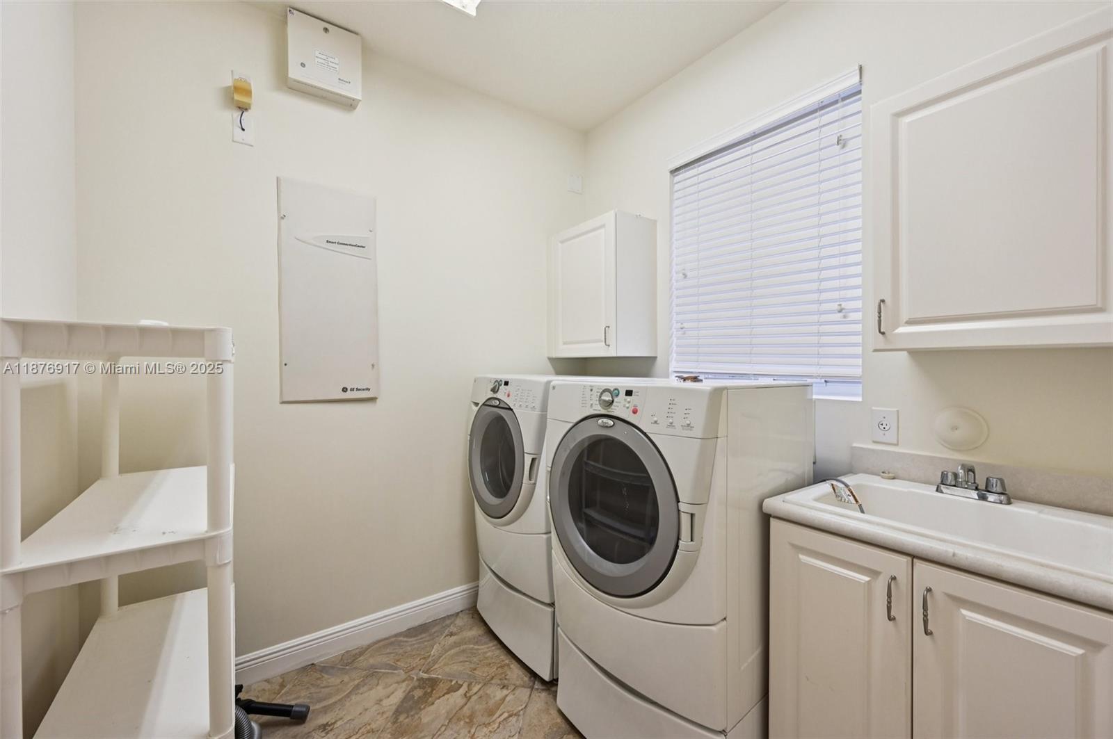 9192 Nugent Trail West Palm Beach, FL 33411 - Photo 43 of 62 a utility room with sink dryer and washer