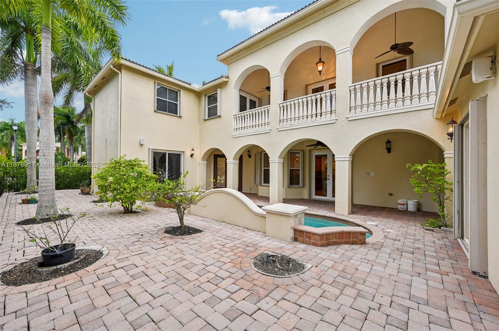 9192 Nugent Trail West Palm Beach, FL 33411 - Photo 55 of 62 a front view of a house with a garden