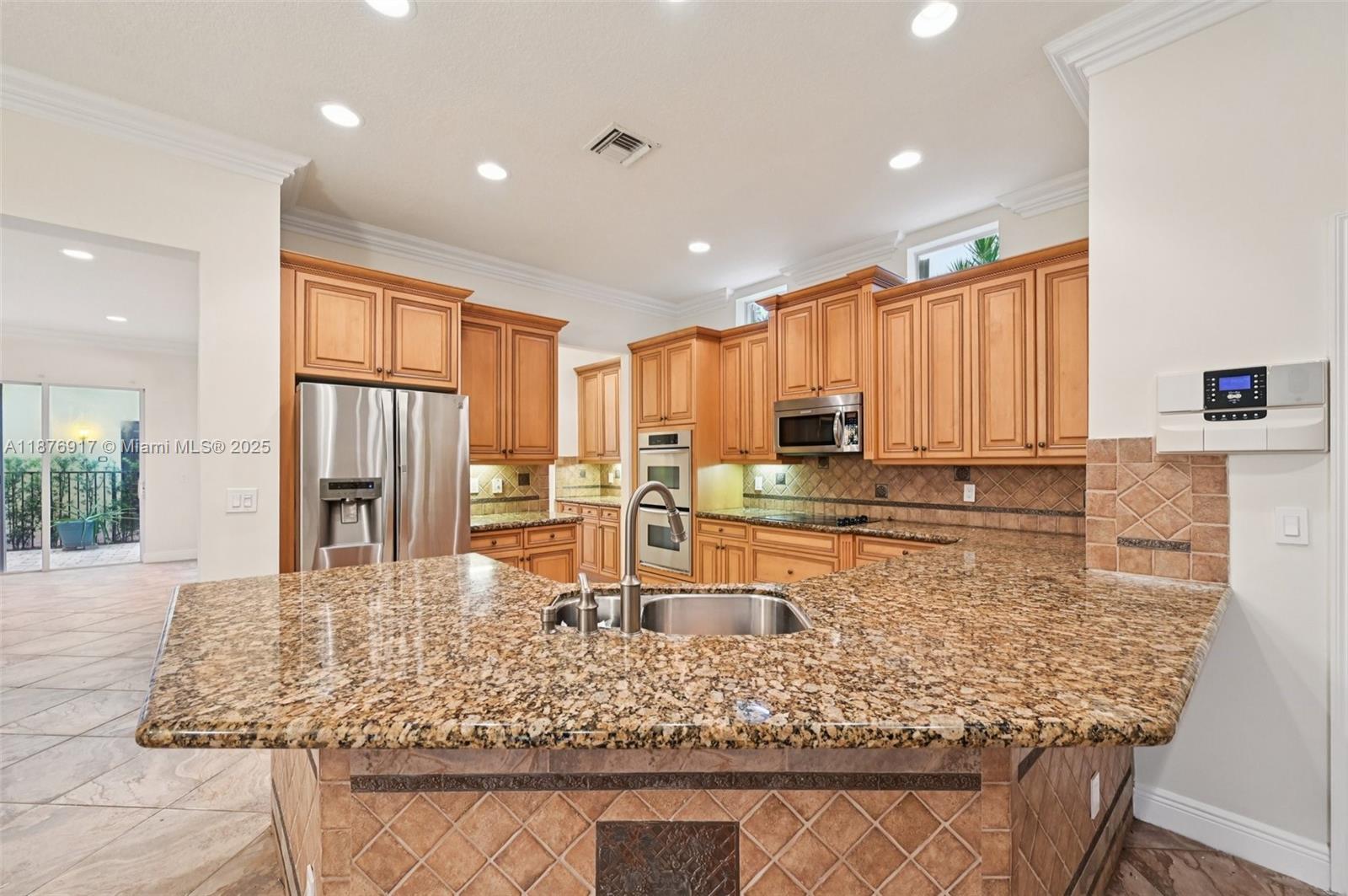 9192 Nugent Trail West Palm Beach, FL 33411 - Photo 9 of 62 a kitchen with stainless steel appliances granite countertop sink stove and refrigerator