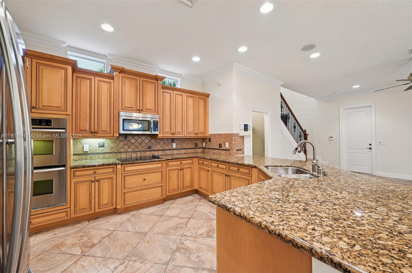 9192 Nugent Trail West Palm Beach, FL 33411 - Photo 10 of 62 a kitchen with stainless steel appliances granite countertop a sink dishwasher stove and refrigerator
