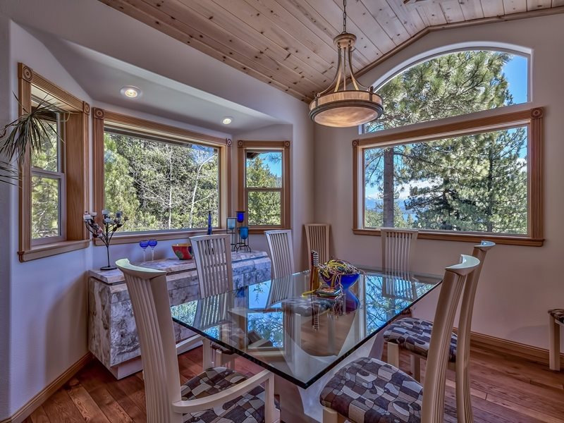 16313 Cinnamon Ridge Place Truckee, CA 96161 - Photo 4 of 10 a view of a dining room with furniture large windows and wooden floor