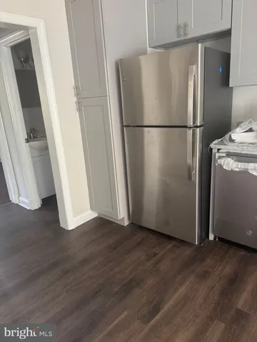 a view of a kitchen with a refrigerator washer and dryer