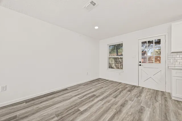 a large kitchen with stainless steel appliances granite countertop a sink a stove and a refrigerator