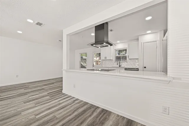a kitchen with stainless steel appliances a refrigerator and a stove top oven