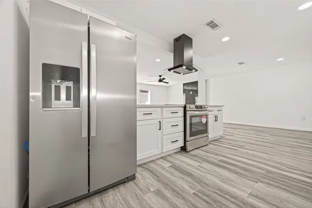 a view of empty room with wooden floor
