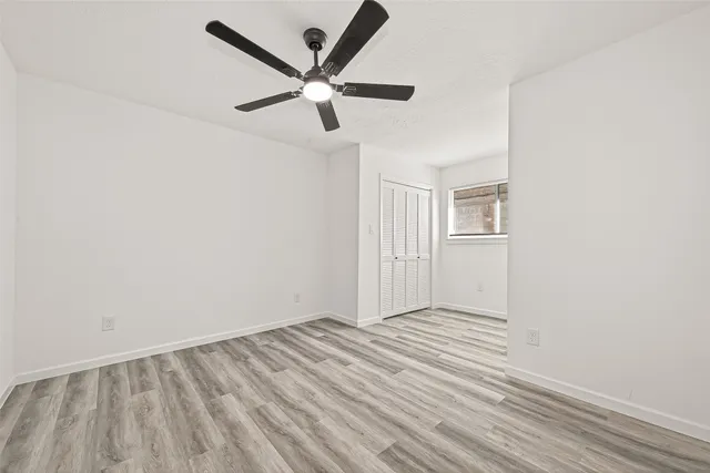 a view of a house with a backyard and a tree