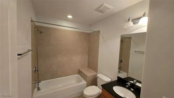 a bathroom with a toilet and a bathtub