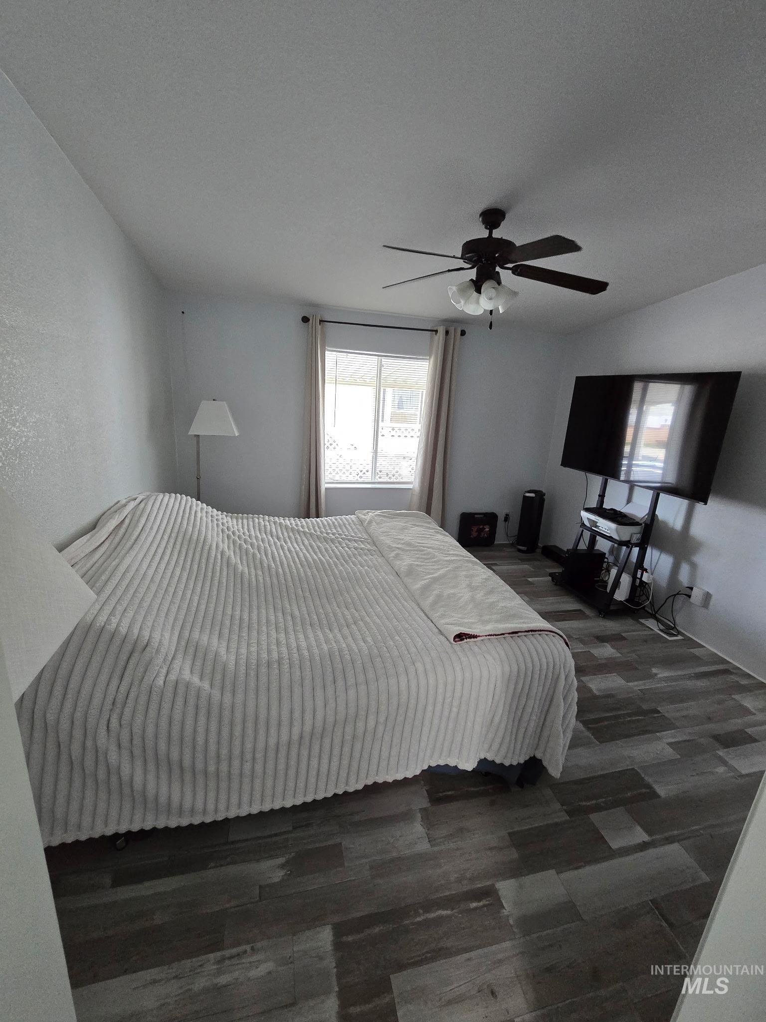 2115 6th Avenue, Unit 51 Clarkston, WA 99403 - Photo 11 of 34 Bedroom featuring ceiling fan and dark wood-style flooring