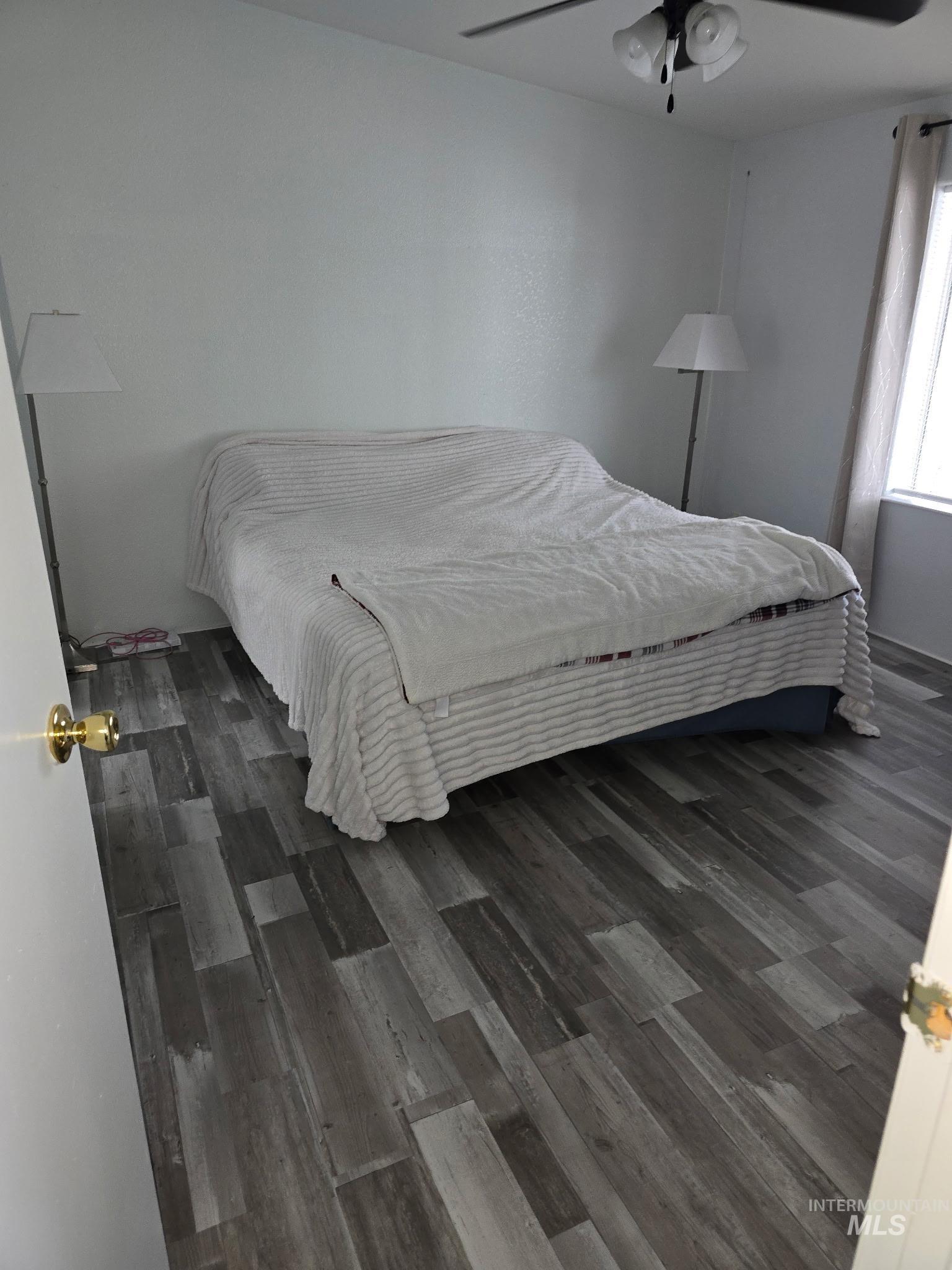 2115 6th Avenue, Unit 51 Clarkston, WA 99403 - Photo 12 of 34 Bedroom with dark wood finished floors and a ceiling fan