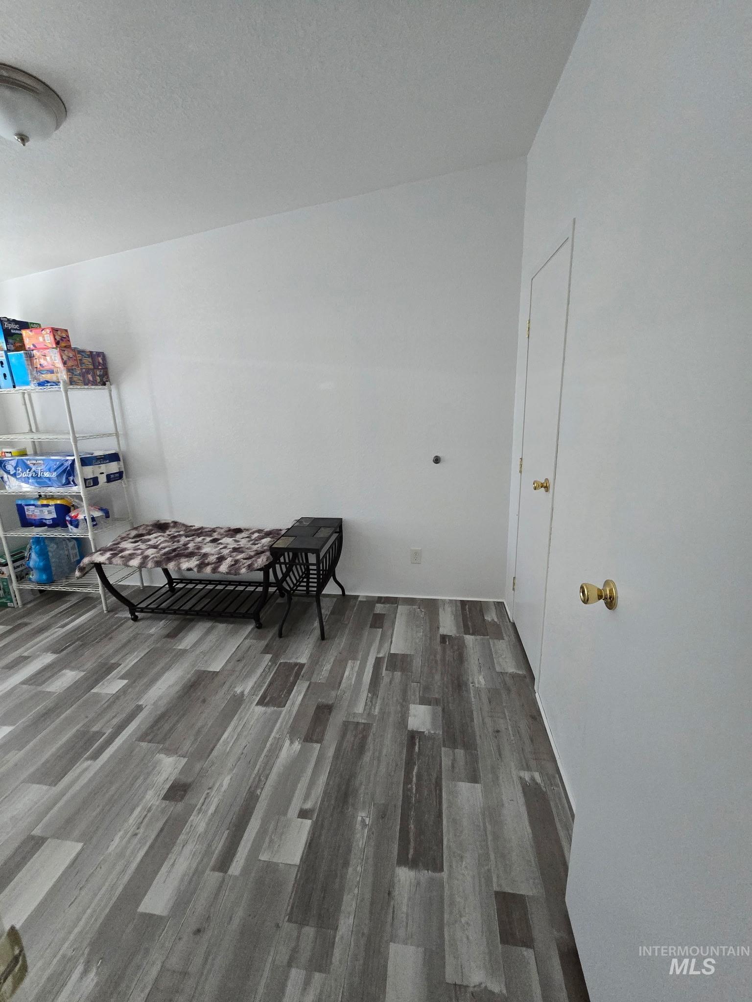 2115 6th Avenue, Unit 51 Clarkston, WA 99403 - Photo 16 of 34 Bonus room featuring dark wood-style flooring and a textured ceiling