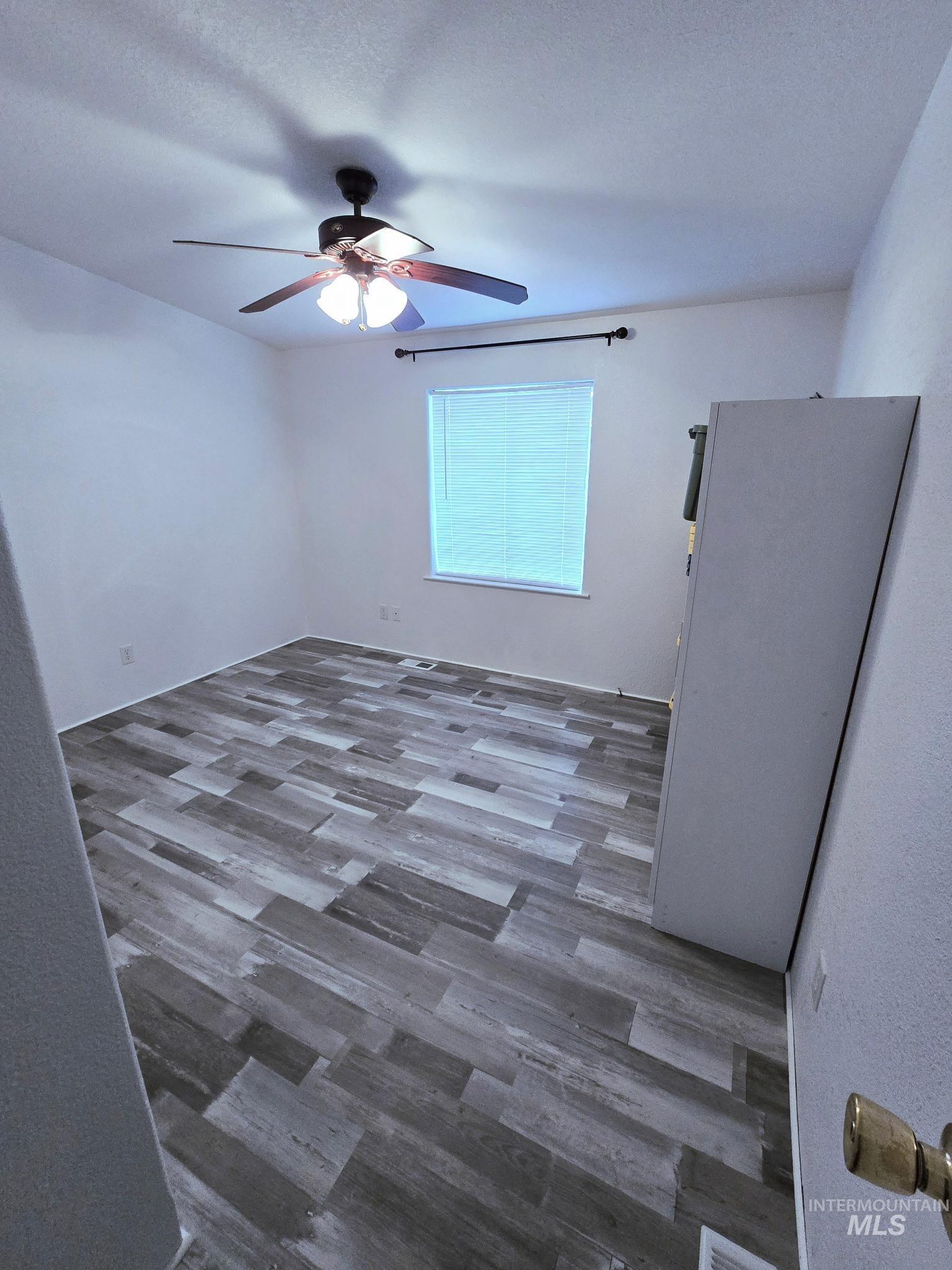 2115 6th Avenue, Unit 51 Clarkston, WA 99403 - Photo 17 of 34 Empty room with dark wood-type flooring and a ceiling fan