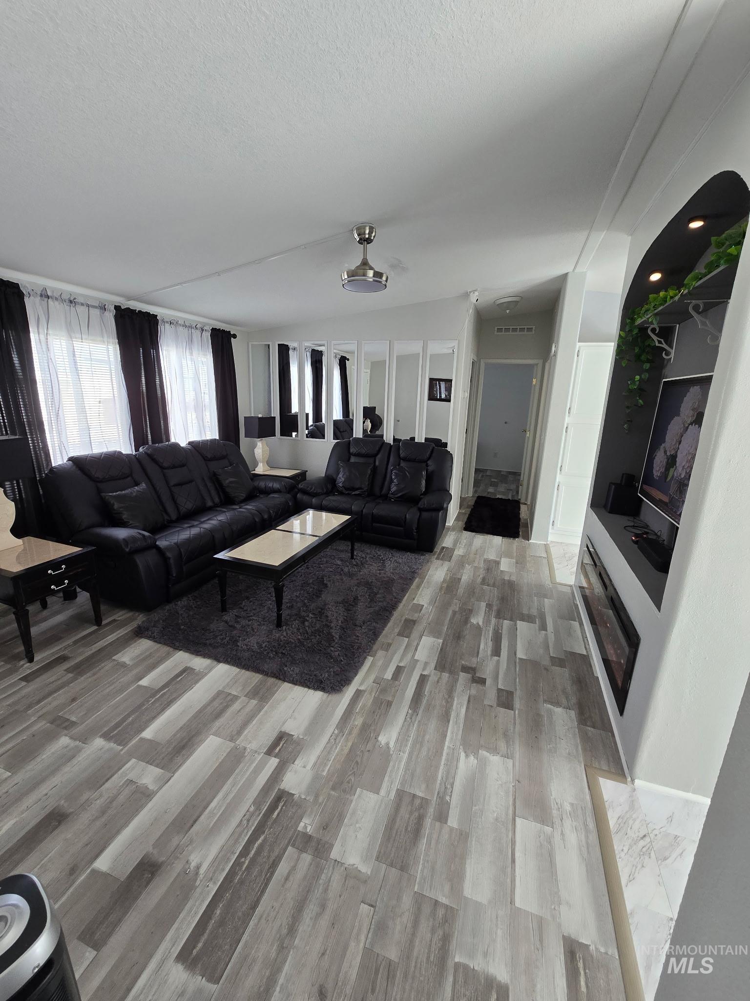 2115 6th Avenue, Unit 51 Clarkston, WA 99403 - Photo 4 of 34 Living area featuring light wood finished floors and a textured ceiling