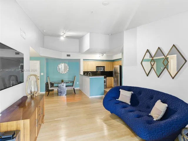 a living room with furniture and a wooden floor