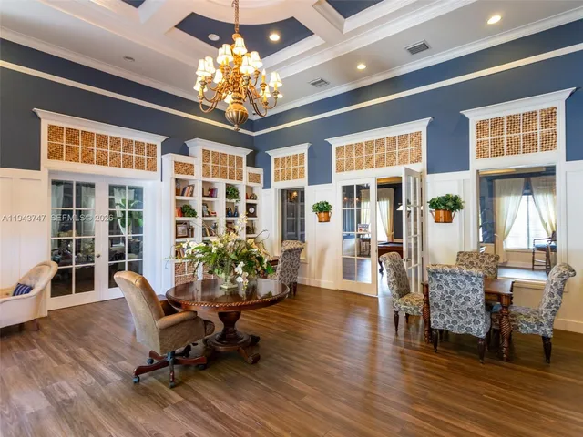 a room with lots of windows and a chandelier