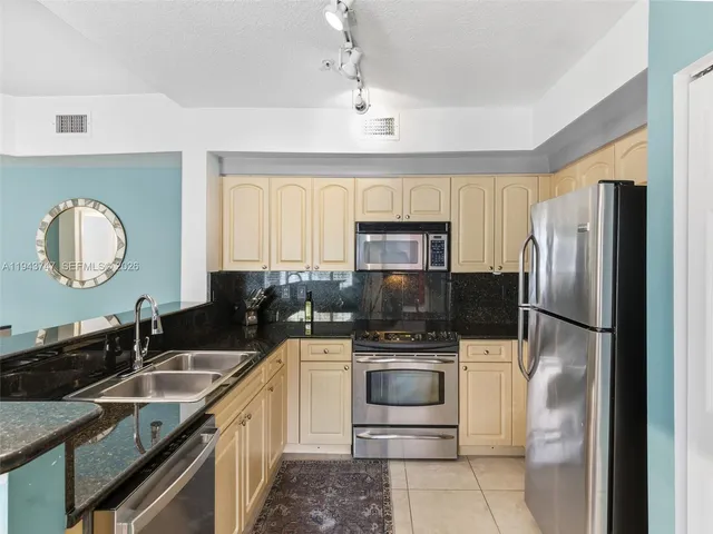 a kitchen with a sink a stove and refrigerator