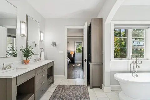 a bathroom with a granite countertop sink a toilet and shower