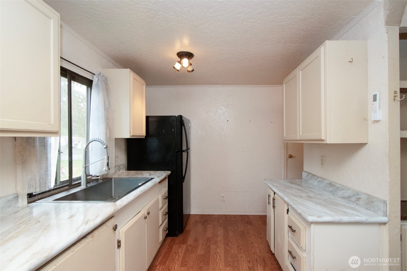 90 Baywood Village Road, Unit 34 Sequim, WA 98382 - Photo 15 of 40 a kitchen with granite countertop a sink stove and refrigerator