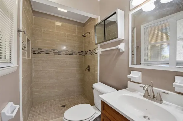 a bathroom with a sink toilet and shower