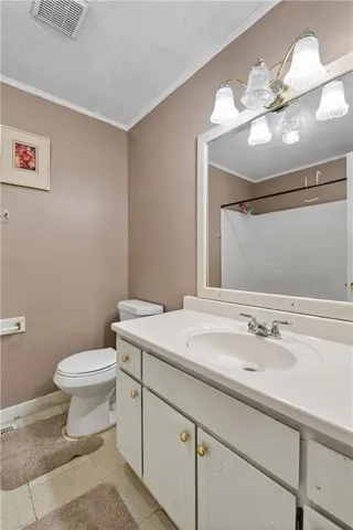 a bathroom with a sink toilet and a mirror