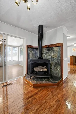 a living room with furniture a fireplace and wooden floor